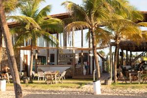 圣米格尔-杜戈斯托苏Casa de Lala Beach House的一间位于酒店前方的棕榈树餐厅