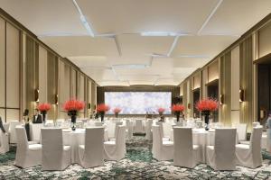 洛阳洛阳万怡酒店的一个带白色桌椅的大型宴会厅