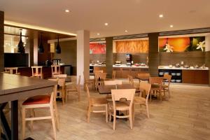 诺加利斯诺加利斯万豪费尔菲尔德酒店 的一间带桌椅的餐厅和一间酒吧