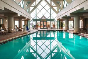 诺福克诺福克海湾万豪酒店 的大楼内带桌椅的游泳池