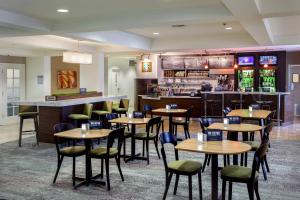 斯托克顿斯托克顿万怡酒店的一间带桌椅的餐厅和一间酒吧