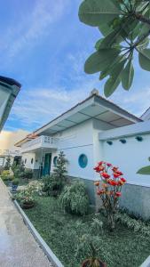 日惹CERIA HOTEL at Alun Alun Yogyakarta的前面有花园的白色房子