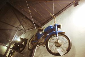 新戈里察GARAGE HOSTEL的挂在房间链上的一辆蓝色摩托车