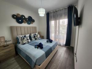 卡勒达德福斯特Ohana home beach and love的一间卧室配有一张带蓝色床单的床和一扇窗户。