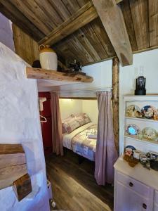 查尔斯敦Tiernan's Luxury Cottages的一间带一张床的卧室,位于带木制天花板的房间内