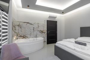 俄斯特拉发OŽA apartmány的白色的浴室设有浴缸和水槽。