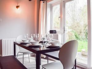 埃文河畔斯特拉特福Sidelands Sojourn的一间带桌椅和窗户的用餐室