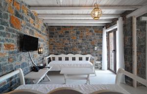 圣加利尼Palazzo Greco Villas的一间卧室设有一张床和砖墙