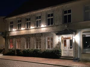 Usedom TownSpurensucher Quartier的一座古老的石头建筑,晚上有灯
