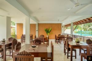 贝鲁沃勒Anura's Elephant的一间带桌椅的餐厅以及一个阳台