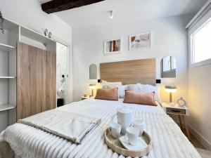 马德里Encantador Tirso Molina Exterior Mesón的白色卧室设有一张带木制床头板的大床