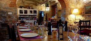 佩拉戈La Fornella dell'Anita的餐厅的桌子,配盘子和酒杯