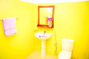 南塔拉拉塔拉拉自由度假村的黄色的浴室设有水槽和卫生间
