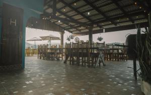 希利特拉Hotel Posada San Agustin的餐厅设有木桌、椅子和遮阳伞