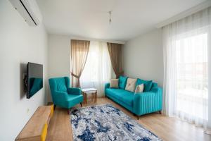 安塔利亚River Park Residence Lara的客厅配有2把蓝色椅子和电视