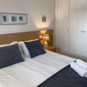 圣玛丽亚港Apartamento en la playa de Valdelagrana的卧室配有白色的床和黑白色枕头