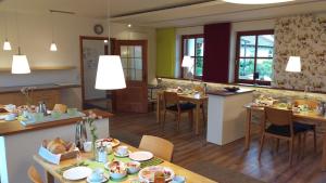 诺尔德海姆Ferienwohnungen Familie Neubert的厨房以及带桌椅的用餐室。