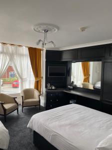 布里德灵顿雷夫尔斯托克酒店的卧室配有一张床、一张桌子和椅子