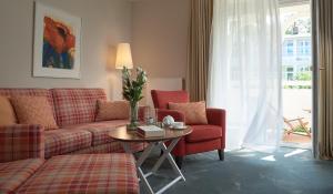 奥斯赛拜-塞林Romantik ROEWERS Privathotel & Spa的客厅配有沙发和桌子