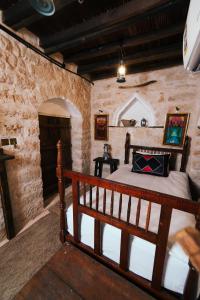 塞拉莱نزل كوفان التراثي Koofan Heritage Lodge的卧室配有一张石墙床