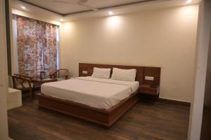 马拉里Hotel Apple Blossom B$B的一间卧室配有一张床、一张桌子和一个窗户。
