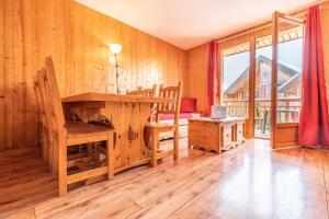 拉菲克拉假日夫人伯杰小屋酒店的木制客房设有书桌、床和窗户。