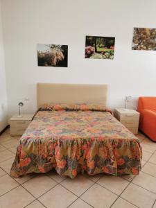 明乔河畔的瓦雷奇奥拉塔梅瑞切住宿加早餐旅馆的卧室配有一张床,墙上挂有两张照片