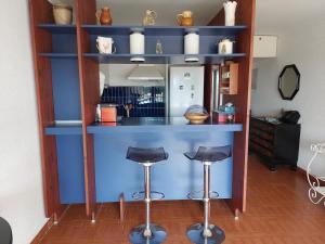 勒格罗-迪鲁瓦Appartement Le Grau-du-Roi, 2 pièces, 6 personnes - FR-1-716-1的一间设有凳子的蓝色酒吧