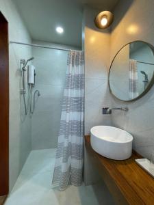 清莱Baan Jai Klang (บ้านใจกลาง)的一间带水槽和镜子的浴室