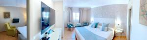 阿尔赫西拉斯阿尔博兰阿尔赫西拉斯酒店的一间卧室配有一张大床和电视