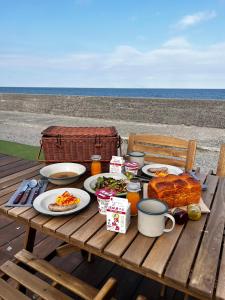 淡路PICNIC　GARDEN的一张带食品和饮料的野餐桌以及海滩