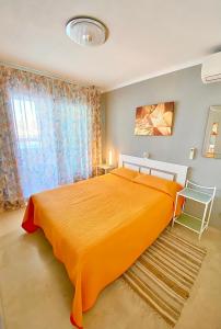 贝尼多姆LuxBenidorm的一间卧室设有一张大型橙色床和一扇窗户。