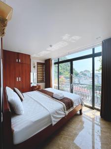 下龙湾CHÉRIE HOMEHOTEL的一间卧室设有一张大床和一个大窗户