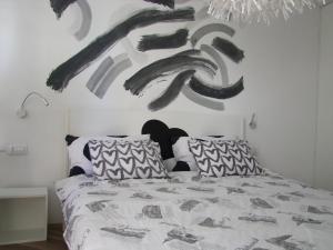 杜布罗夫尼克A bright hideaway的卧室配有一张床,墙上挂有绘画作品