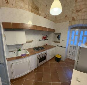 洛科罗通多trulli Annina的厨房配有水槽和炉灶 顶部烤箱