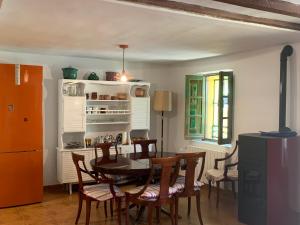 Alameda del ValleLa Toscana en Lozoya的厨房以及带桌椅的用餐室。
