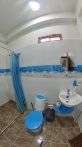 帕洛米诺Hostal Grand Park Palomino的浴室设有蓝色的卫生间和水槽。