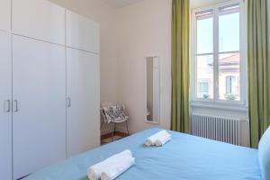 米兰[Duomo/Navigli] Casa Elegante in zona Tortona的一间卧室设有蓝色的床和窗户。