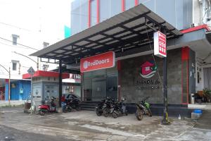 直葛RedDoorz near Taman Pantai Alam Indah Tegal的停在商店前的一组摩托车