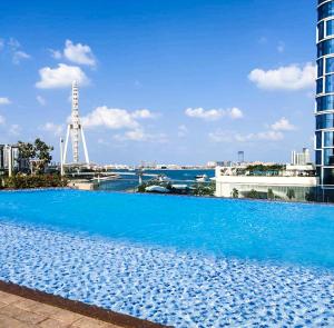 迪拜MarinaVista Bluewaters Island 52 42 Dubai Marina 2 BR-Beach-Sea View的一座大型蓝色游泳池,位于一座建筑的顶部