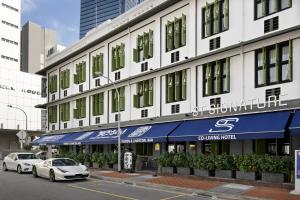 新加坡ST Signature Tanjong Pagar, DAYUSE, 8 hours, 10AM-6PM的一座白色的建筑,前面有汽车停放