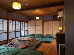 　Komori Village GH ～小森ヴィレッジ ゲストハウス～ 自然の中にある庭付平屋一棟貸的一间设有三张床的房间,内设一张桌子