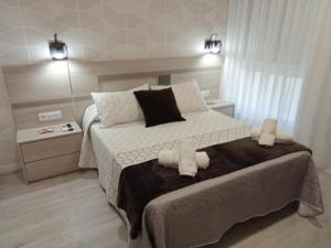 萨里亚Baixo a Lua Rooming的一间卧室配有一张大床和两条毛巾