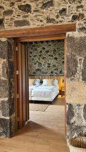 特尔德Finca La Suerte Grande的卧室配有一张石墙床