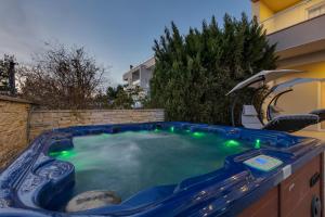 马卡尔斯卡Apartments Lujnovic的后院的带绿灯的热水浴池