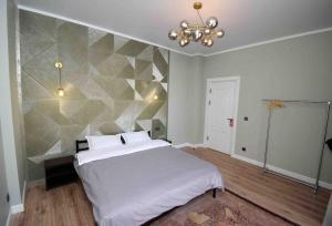 TürkistanАпартамент keruen saray的一间卧室设有一张床和几何墙