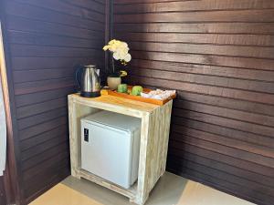 珀尼达岛Villa Vilah的客房内的一张小木桌和冰箱