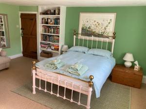 CudworthCorner House的一间卧室设有一张床和一个书架