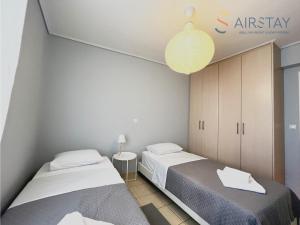 斯巴达Elise Apartment Airport by Airstay的一间卧室配有两张床和灯具