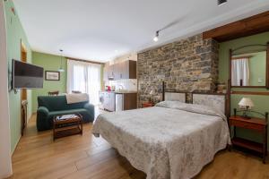 博尔塔纳Casa Dieste Apartamentos Turísticos en Boltaña的一间卧室设有一张床和石墙